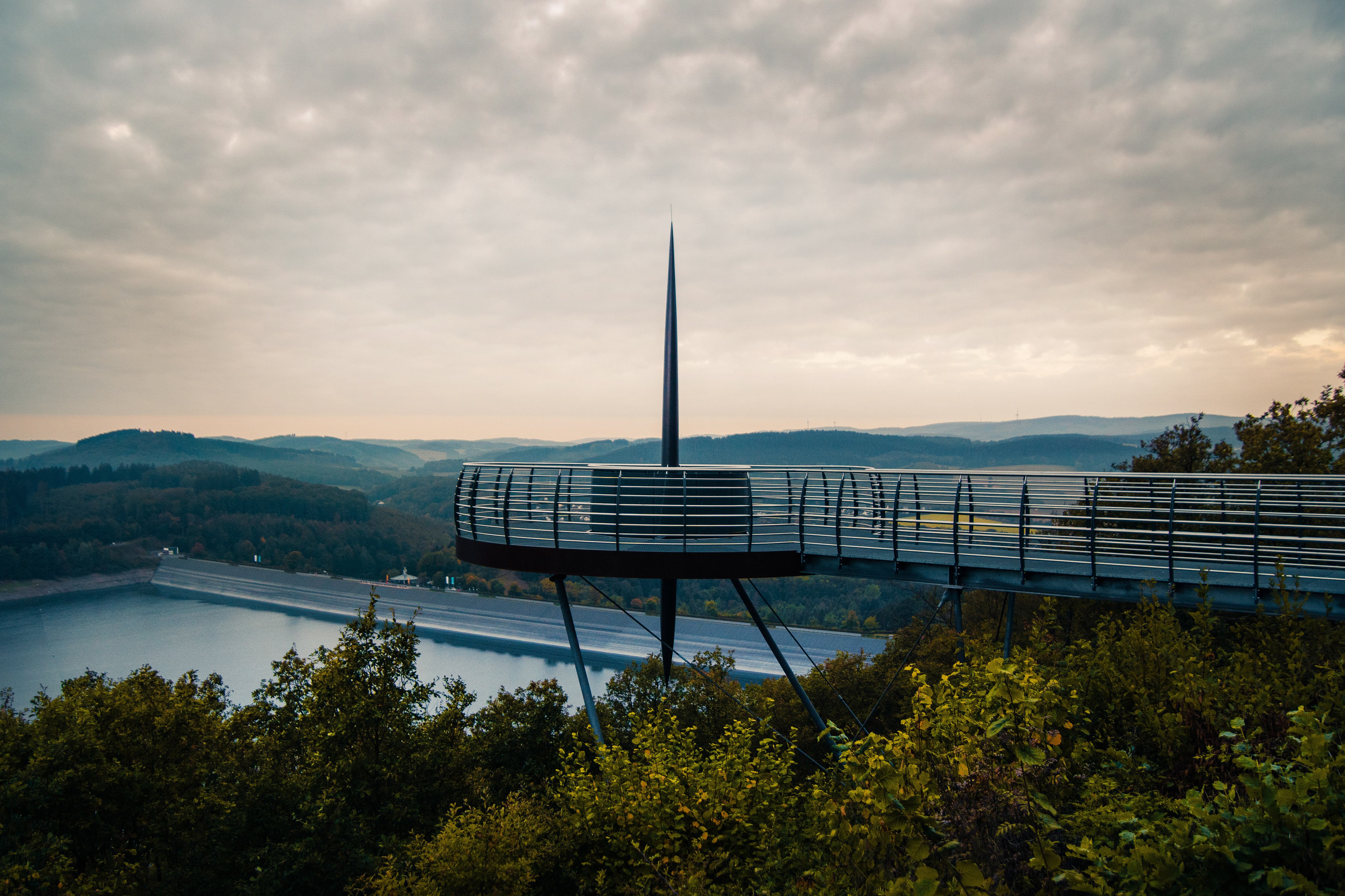 Der stählerne Steg und die frei hängende Aussichtsplattform des Skywalks Biggeblick über den Baumwipfeln am Biggesee