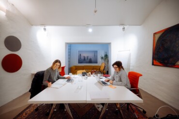 Im Co-Working-Space Wertheim in Köln arbeiten zwei Frauen an Laptops an zwei Tischen. 